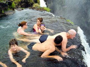 Thrill seekers of all ages enjoy a frolic at the top of the 355' Victoria Falls