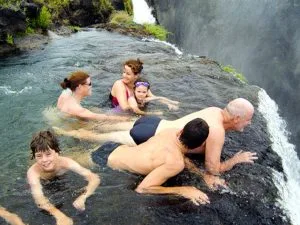 Thrill seekers of all ages enjoy a frolic at the top of the 355' Victoria Falls