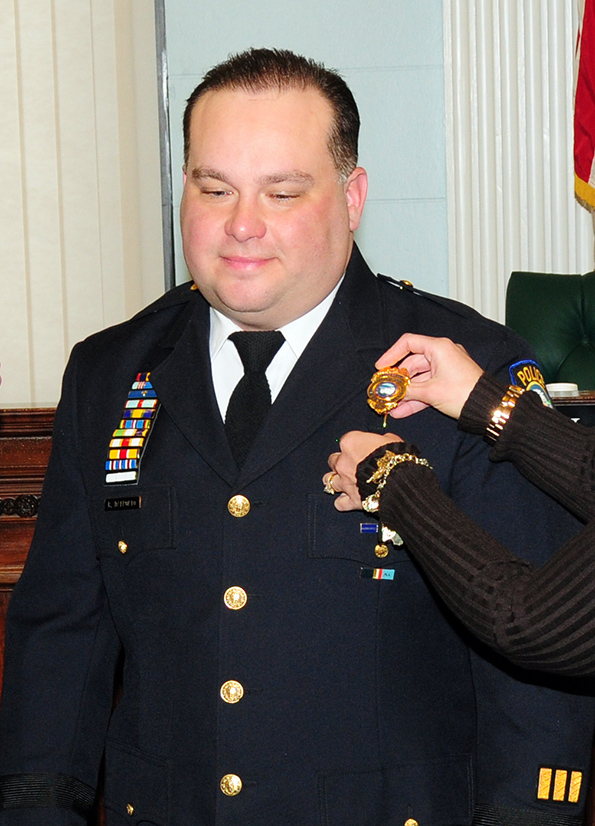 Major Bryan DalPorto 107th Airlift Wing’s Force Support Squadron (FSS) Commander was named the new police superintendent for the city of Niagara Falls N. Y. Mayor Paul Dyster and wife Eveyln DalPorto pin the badge and rank on Jan, 4, 2013 (Air National Guard Photo/Senior Master Sgt Ray Lloyd)