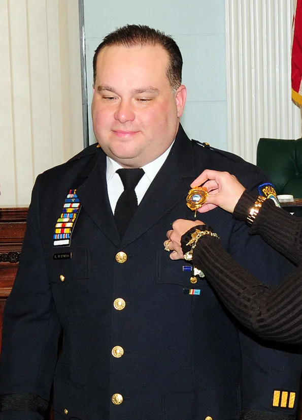 Major Bryan DalPorto 107th Airlift Wing’s Force Support Squadron (FSS) Commander was named the new police superintendent for the city of Niagara Falls N. Y. Mayor Paul Dyster and wife Eveyln DalPorto pin the badge and rank on Jan, 4, 2013 (Air National Guard Photo/Senior Master Sgt Ray Lloyd)
